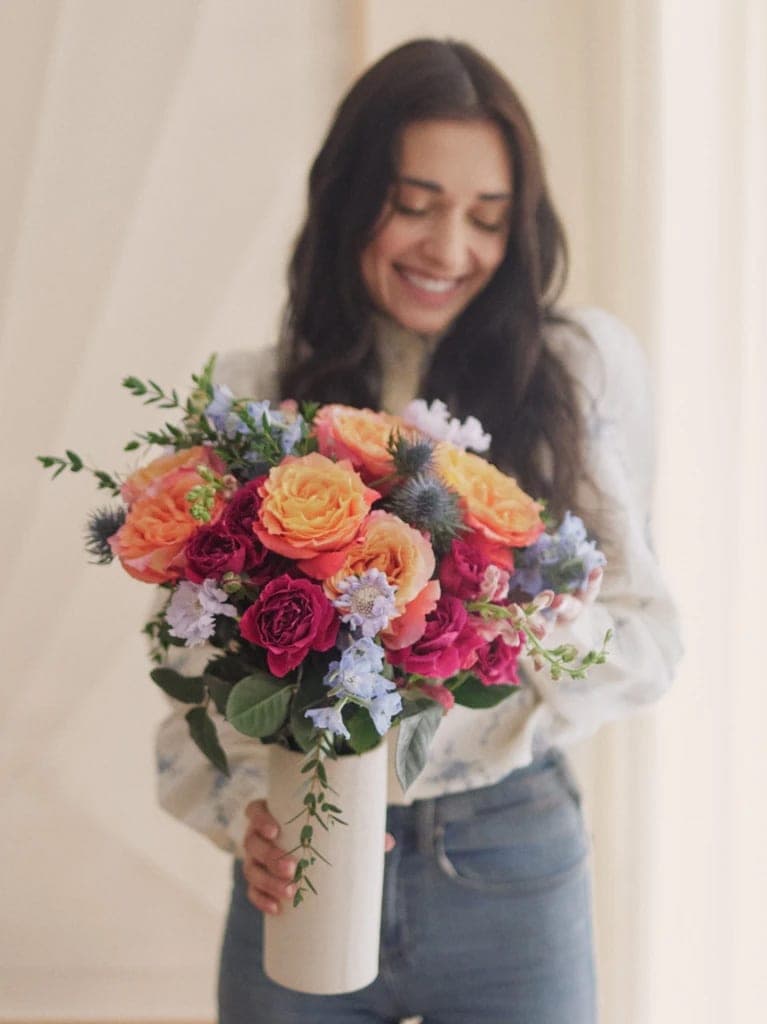 Alix, a bold jewel toned arrangement in a brass vase